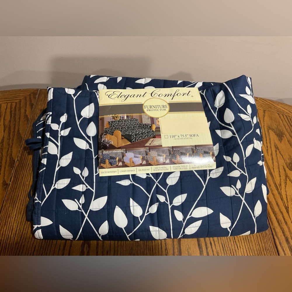 Sofa cover in navy blue & white leaf pattern reverses to solid navy blue